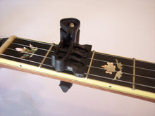 Load image into Gallery viewer, It capos the string right at the fret, not between the frets, to minimize pulling your instrument out of tune.