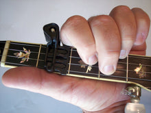 Load image into Gallery viewer, It stays out of way of your hand movements. - It capos the string right at the fret, not between the frets, Your can actually slide BEHIND the capo, as when you're playing a "C" chord, as shown.