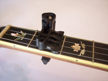 Load image into Gallery viewer, It capos the string right at the fret, not between the frets, to minimize pulling your instrument out of tune.
